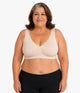 Plus-size woman wearing the OnlyShape Everywear Bra in nude — seamless comfort bra, invisible under clothing, plus-size inclusive fit